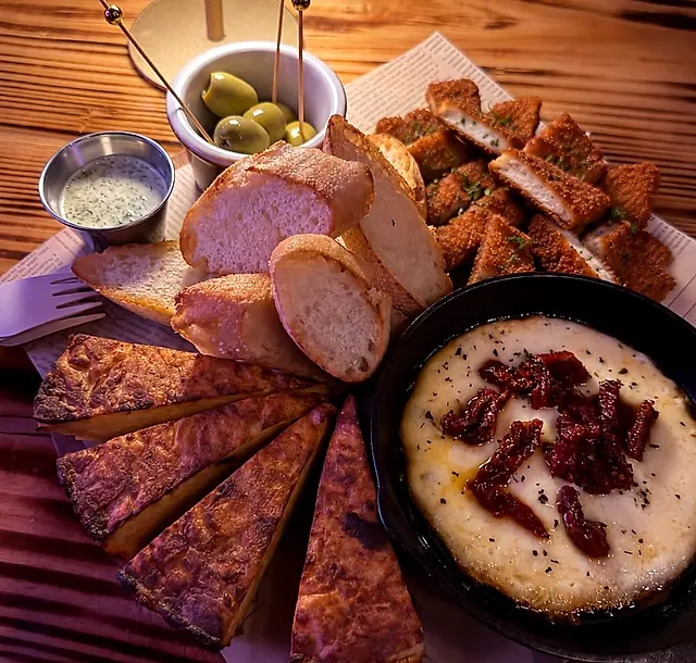 La Klandestina platter at Klandestino Lounge: Spanish potato tortilla, melted provolone with sun-dried tomatoes, olives, bread and Klandestino aioli